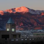 Pikes Peak glows pink and orange during a winter sunrise. Photo by Tom Kimmell